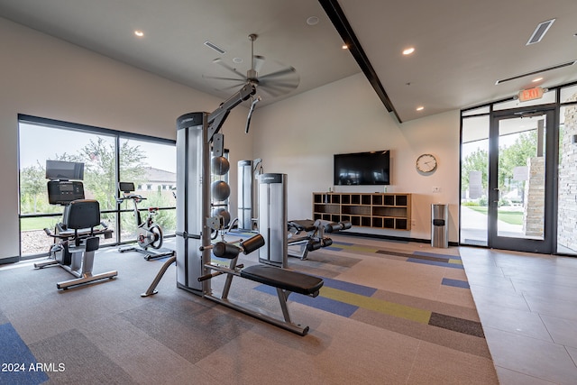 workout area with ceiling fan and high vaulted ceiling