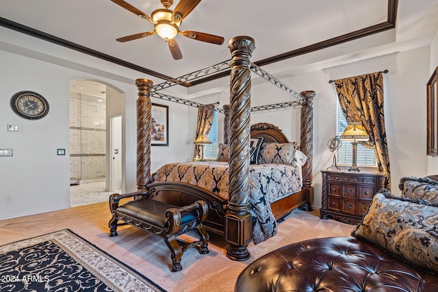 carpeted bedroom featuring connected bathroom, ceiling fan, and crown molding