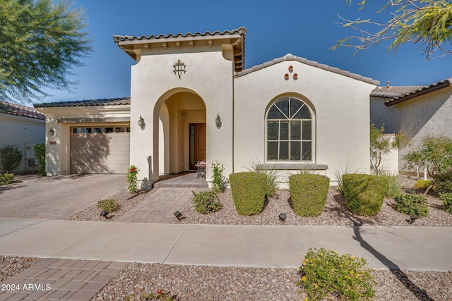 mediterranean / spanish house featuring a garage