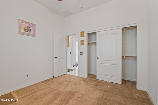 unfurnished bedroom featuring carpet flooring, a closet, and ceiling fan