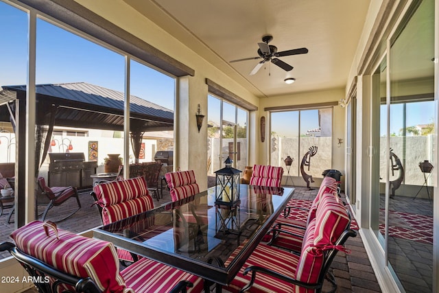 sunroom / solarium featuring ceiling fan