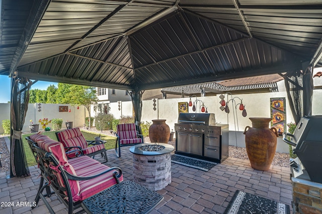 view of patio featuring a gazebo, an outdoor fire pit, and grilling area