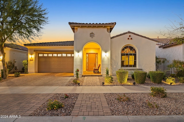 mediterranean / spanish home with a garage