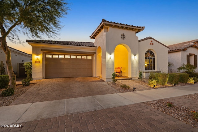 mediterranean / spanish house featuring a garage