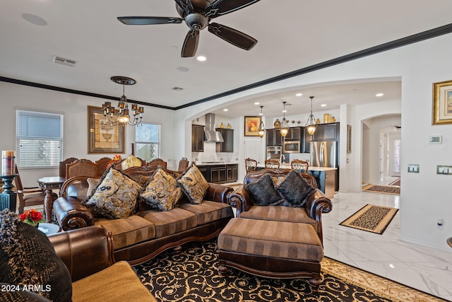 living room featuring ceiling fan with notable chandelier and ornamental molding