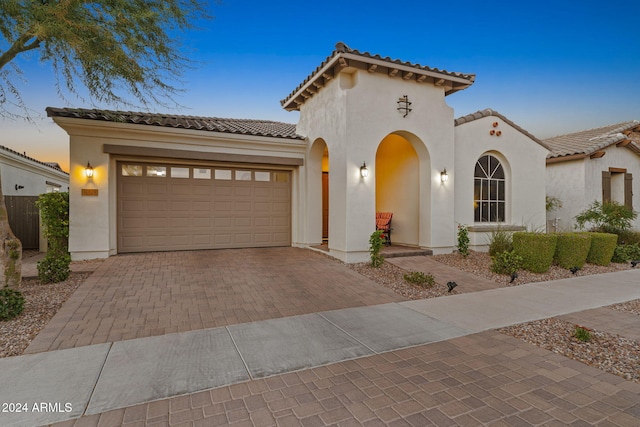 mediterranean / spanish home with a garage