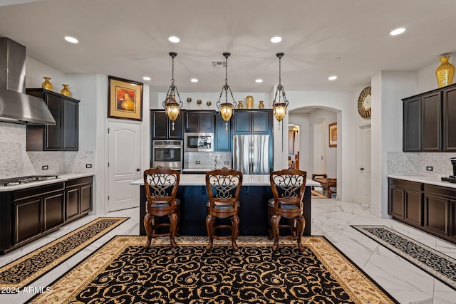 kitchen featuring decorative backsplash, wall chimney exhaust hood, and appliances with stainless steel finishes