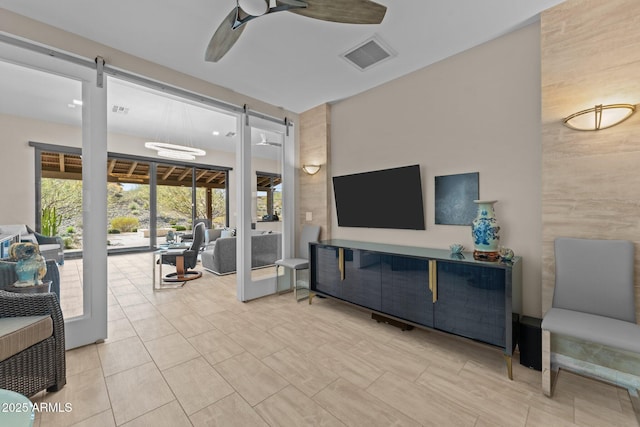 4093 Miners Gulch Way, Wickenburg, AZ 85390 - living area with a barn door, ceiling fan, and visible vents