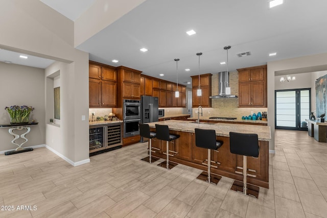 4093 Miners Gulch Way, Wickenburg, AZ 85390 - kitchen featuring a sink, wall chimney exhaust hood, stainless steel double oven, visible vents, and decorative backsplash