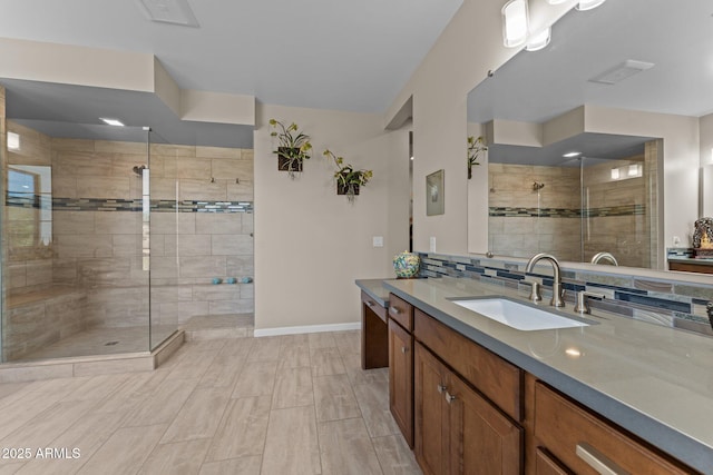 4093 Miners Gulch Way, Wickenburg, AZ 85390 - bathroom featuring vanity, a shower stall, baseboards, visible vents, and decorative backsplash