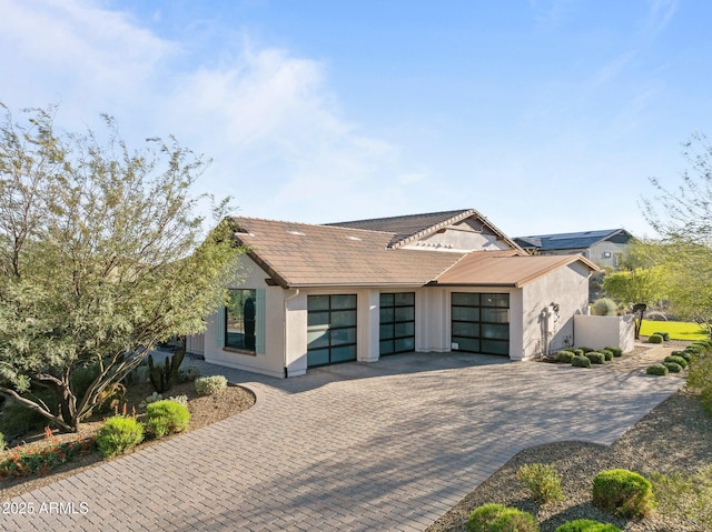 4093 Miners Gulch Way, Wickenburg, AZ 85390 - view of front facade featuring a tile roof, stucco siding, fence, decorative driveway, and a garage