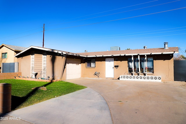 single story home with a front yard and a garage