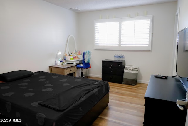 bedroom with light wood-type flooring