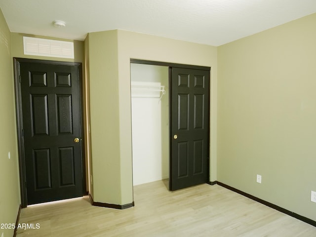 43241 W Kristal Ln, Maricopa, AZ 85138 - unfurnished bedroom featuring light wood finished floors, baseboards, and a closet