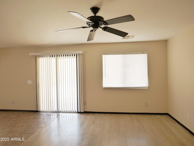 43241 W Kristal Ln, Maricopa, AZ 85138 - empty room with baseboards, a ceiling fan, and light wood-type flooring