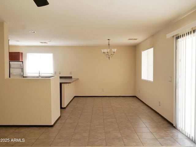 43241 W Kristal Ln, Maricopa, AZ 85138 - kitchen with a chandelier, built in refrigerator, baseboards, and decorative light fixtures