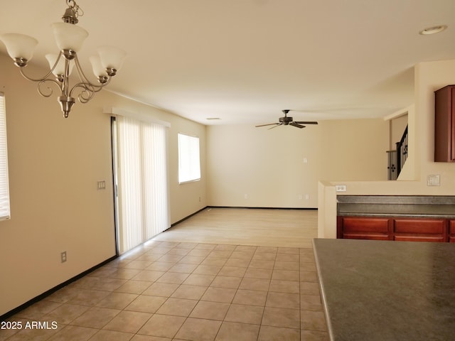 43241 W Kristal Ln, Maricopa, AZ 85138 - unfurnished living room featuring ceiling fan, a chandelier, light tile patterned flooring, and baseboards