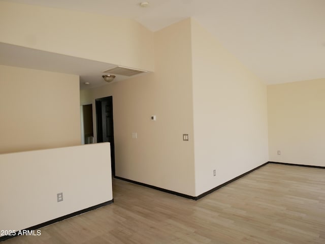 43241 W Kristal Ln, Maricopa, AZ 85138 - empty room with vaulted ceiling, light wood-type flooring, and baseboards