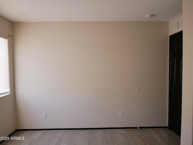 43241 W Kristal Ln, Maricopa, AZ 85138 - empty room featuring plenty of natural light, a smoke detector, light wood-style floors, and baseboards