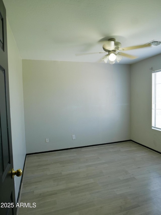 43241 W Kristal Ln, Maricopa, AZ 85138 - spare room featuring a ceiling fan, wood finished floors, and baseboards