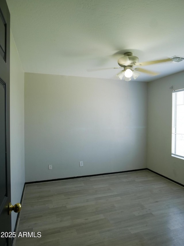 43241 W Kristal Ln, Maricopa, AZ 85138 - spare room with ceiling fan, wood finished floors, and baseboards