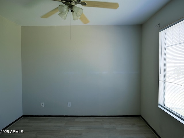 43241 W Kristal Ln, Maricopa, AZ 85138 - spare room with healthy amount of natural light, a ceiling fan, and wood finished floors