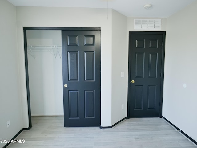 43241 W Kristal Ln, Maricopa, AZ 85138 - unfurnished bedroom with a closet, light wood-style flooring, and baseboards
