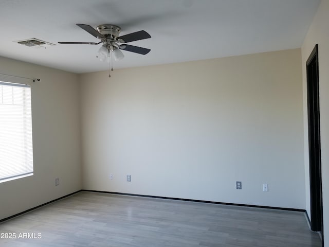 43241 W Kristal Ln, Maricopa, AZ 85138 - spare room with ceiling fan, light wood finished floors, and baseboards