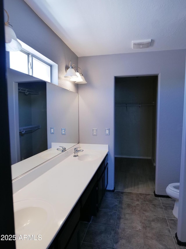 43241 W Kristal Ln, Maricopa, AZ 85138 - bathroom with toilet, double vanity, and a spacious closet