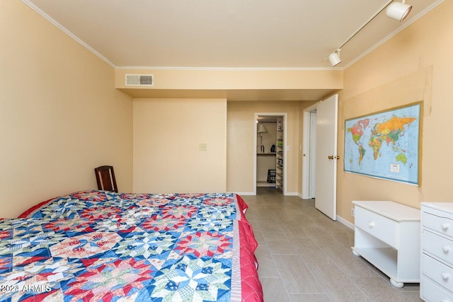 bedroom with ornamental molding and rail lighting