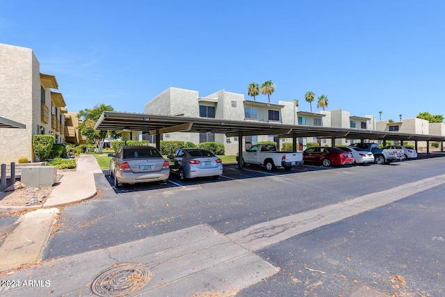 view of parking / parking lot featuring a carport