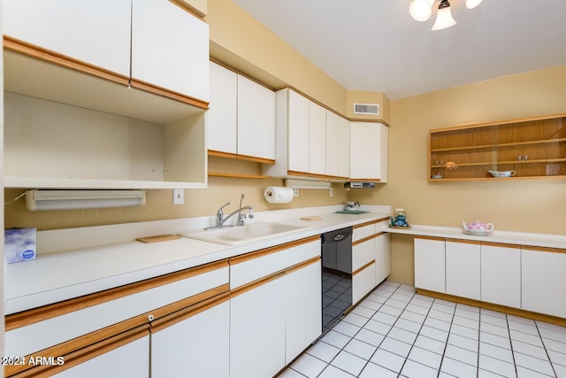 kitchen featuring light tile patterned flooring, white cabinets, black dishwasher, and sink