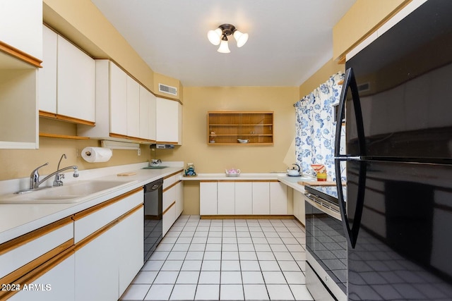 kitchen with white cabinetry, black appliances, sink, and light tile patterned floors