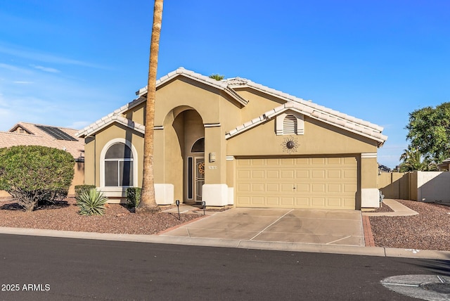 view of front of house with driveway, an attached garage, a tile roof, and stucco siding