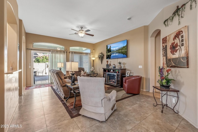 living room featuring a ceiling fan and light tile patterned floors