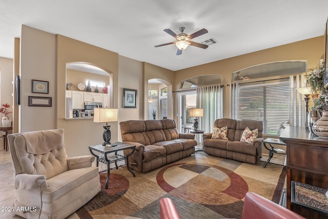 living area with visible vents and a ceiling fan