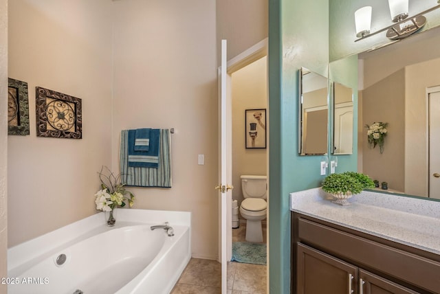 bathroom with toilet, tile patterned floors, a bath, and vanity