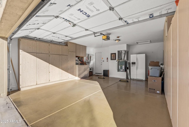 garage with white fridge with ice dispenser and a garage door opener