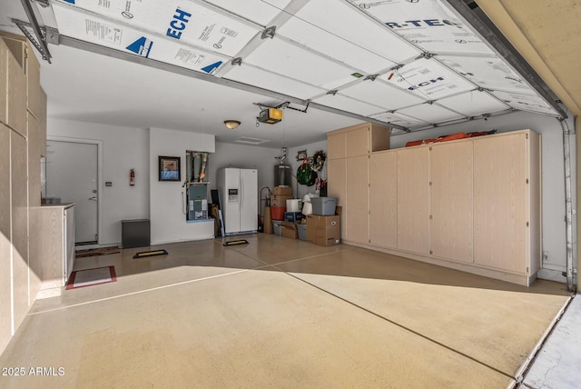 garage featuring white fridge with ice dispenser, gas water heater, and a garage door opener