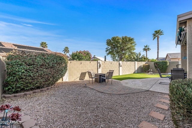 view of yard featuring a patio area and a fenced backyard