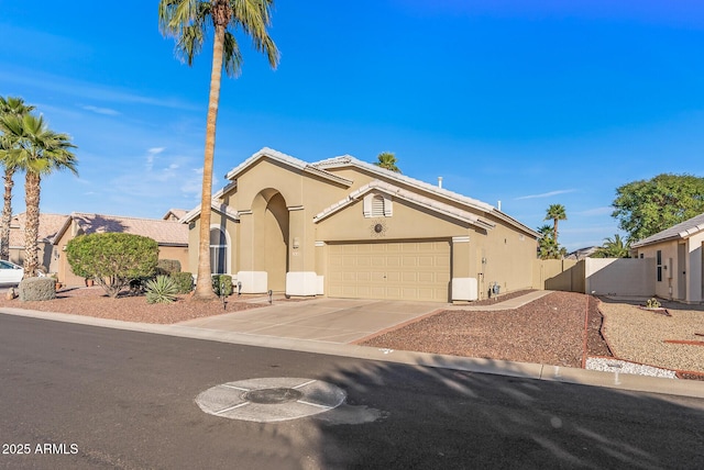 view of front of house featuring driveway, a garage, and stucco siding