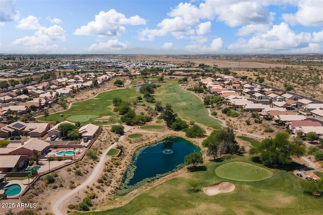 drone / aerial view featuring view of golf course, a water view, and a residential view