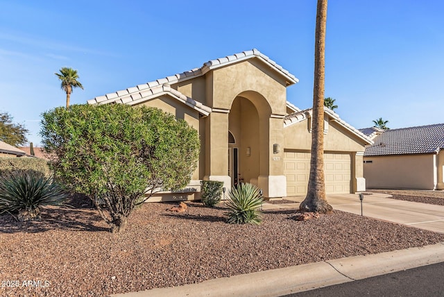 view of front of property featuring concrete driveway, a tile roof, an attached garage, and stucco siding