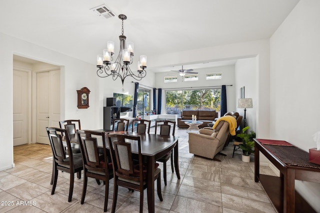 dining area featuring ceiling fan with notable chandelier