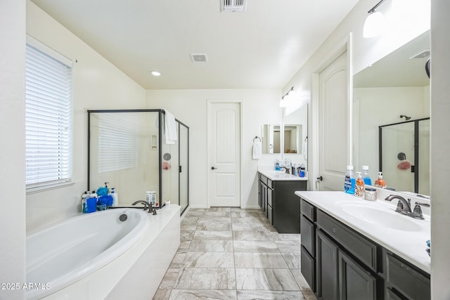 bathroom featuring vanity and separate shower and tub