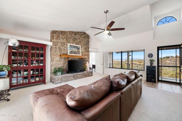 128 N French Dr, Prescott, AZ 86303 - carpeted living room featuring a ceiling fan, a stone fireplace, high vaulted ceiling, and tile patterned flooring