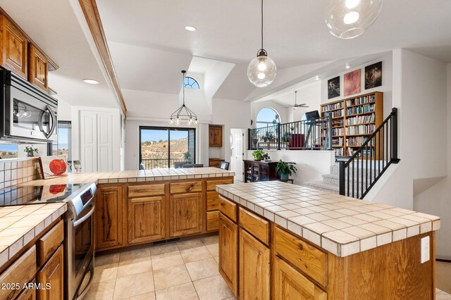 128 N French Dr, Prescott, AZ 86303 - kitchen featuring tile countertops, appliances with stainless steel finishes, brown cabinets, a ceiling fan, and light tile patterned flooring