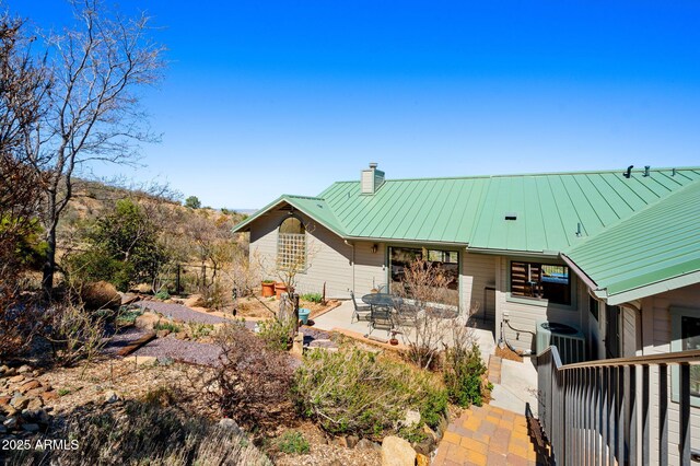 128 N French Dr, Prescott, AZ 86303 - rear view of property featuring a patio, a chimney, and metal roof