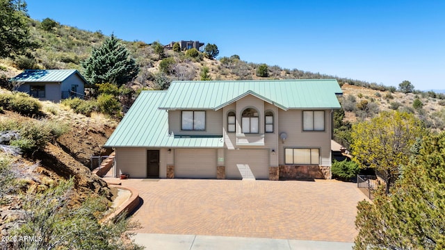 128 N French Dr, Prescott, AZ 86303 - view of front of house with a garage, decorative driveway, stone siding, and metal roof