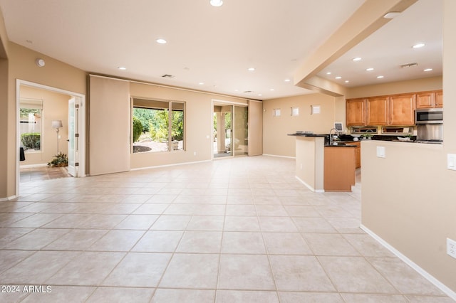 kitchen featuring kitchen peninsula and light tile patterned flooring